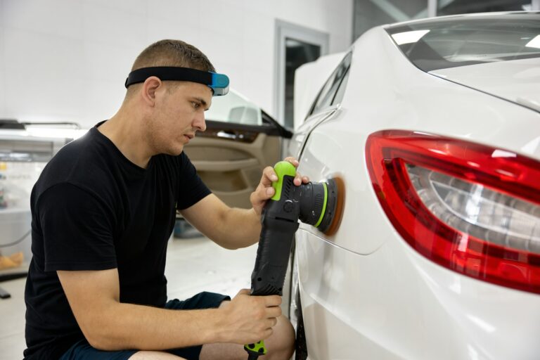 Car service worker applying special nano-ceramic polish cream